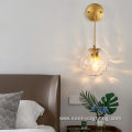 Copper wall lamp with suspended grain glass ball